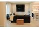 Inviting living room with modern furniture, large television, and views into the kitchen at 3669 E Boot Track Trl, Gilbert, AZ 85296