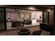 Expansive indoor/outdoor living space with a patio, fire pit, and a view of the modern living room and kitchen at 3669 E Boot Track Trl, Gilbert, AZ 85296