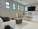 Spacious playroom featuring a play kitchen, table, and soft carpet at 3669 E Boot Track Trl, Gilbert, AZ 85296