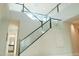 Bright, modern staircase with glass railing and natural light at 3669 E Boot Track Trl, Gilbert, AZ 85296