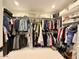 Walk-in closet with custom shelving and hanging rods for optimal storage and organization at 3669 E Boot Track Trl, Gilbert, AZ 85296
