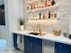 A fully stocked and stylish wet bar featuring modern design and finishes at 3669 E Boot Track Trl, Gilbert, AZ 85296