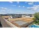 A modern home with pristine landscaping and an unfinished construction site, captured from above at 3933 E Freeman Ln, San Tan Valley, AZ 85140