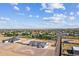 Panoramic aerial view of a newly built home with xeriscaping, surrounded by houses and desert landscape at 3933 E Freeman Ln, San Tan Valley, AZ 85140