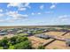 Wide aerial view of the neighborhood homes and land on a sunny day with blue skies at 3933 E Freeman Ln, San Tan Valley, AZ 85140