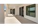 Covered back patio with modern doors and a view of the dirt backyard in a newly built home at 3933 E Freeman Ln, San Tan Valley, AZ 85140