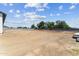 Expansive vacant backyard ready for landscaping with a view of trees and blue sky on a sunny day at 3933 E Freeman Ln, San Tan Valley, AZ 85140