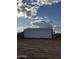 Barn exterior with white paneling and black trim, featuring a simple, functional design at 3933 E Freeman Ln, San Tan Valley, AZ 85140
