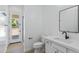 This bathroom offers white cabinets and trim and a sleek black faucet and hardware at 3933 E Freeman Ln, San Tan Valley, AZ 85140