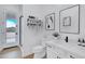 Bright bathroom featuring a quartz vanity, black hardware, and a glass-enclosed shower with desert view at 3933 E Freeman Ln, San Tan Valley, AZ 85140