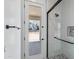 The bathroom features a glass shower, black hardware, and natural light at 3933 E Freeman Ln, San Tan Valley, AZ 85140