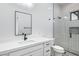 Modern bathroom featuring white cabinets, a quartz countertop, decorative tiles and glass-enclosed shower at 3933 E Freeman Ln, San Tan Valley, AZ 85140