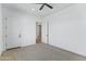Spacious bedroom with carpet, ceiling fan, and two doors at 3933 E Freeman Ln, San Tan Valley, AZ 85140