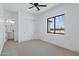 Bright bedroom with ceiling fan, closet, a window with an exterior view at 3933 E Freeman Ln, San Tan Valley, AZ 85140
