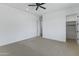 Spacious bedroom featuring a ceiling fan, neutral carpet, closet and doorways at 3933 E Freeman Ln, San Tan Valley, AZ 85140