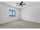 This bedroom features a window to the backyard, neutral carpet, and ceiling fan at 3933 E Freeman Ln, San Tan Valley, AZ 85140