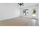 This bedroom features a ceiling fan, neutral carpet, and window to the backyard at 3933 E Freeman Ln, San Tan Valley, AZ 85140