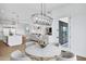 Open-concept dining area with modern chandelier and views of the living room at 3933 E Freeman Ln, San Tan Valley, AZ 85140