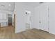 View from kitchen through a bright entryway and an open door to a room with wood-look floors at 3933 E Freeman Ln, San Tan Valley, AZ 85140