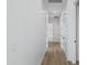 Bright hallway showcasing white walls, wood-look floors and doorways at 3933 E Freeman Ln, San Tan Valley, AZ 85140