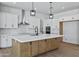 Kitchen boasts a large island, stainless steel appliances, and sleek white cabinetry at 3933 E Freeman Ln, San Tan Valley, AZ 85140
