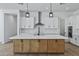 Beautiful kitchen featuring an island with quartz countertops, subway tile backsplash and pendant lighting at 3933 E Freeman Ln, San Tan Valley, AZ 85140