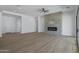 A spacious living room showcasing fireplace with hardwood floors and neutral walls at 3933 E Freeman Ln, San Tan Valley, AZ 85140