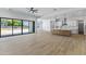 Bright open-concept living space featuring a modern kitchen with a large island and sliding glass doors at 3933 E Freeman Ln, San Tan Valley, AZ 85140