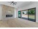 Light and bright living room featuring a brick fireplace and sliding glass doors to the backyard at 3933 E Freeman Ln, San Tan Valley, AZ 85140