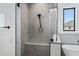 Large walk-in shower with marble surround, bench seat and black hardware with a window at 3933 E Freeman Ln, San Tan Valley, AZ 85140
