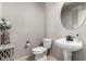 Elegant powder room includes a decorative mirror, pedestal sink, and a stylish floral arrangement at 4061 E Torrey Pines Ln, Chandler, AZ 85249