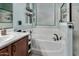 Bright bathroom featuring a soaking tub and vanity storage in light blue at 4061 E Torrey Pines Ln, Chandler, AZ 85249