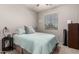 Neutral bedroom featuring a comfortable bed, window views, and simple furnishings at 4061 E Torrey Pines Ln, Chandler, AZ 85249