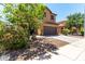Beautiful two-story home with desert landscaping, a concrete driveway, and large trees at 4061 E Torrey Pines Ln, Chandler, AZ 85249