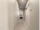 Hallway with neutral carpet leading to bedroom, featuring storage and a thermostat at 4061 E Torrey Pines Ln, Chandler, AZ 85249