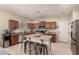 Well-equipped kitchen includes granite countertops, stainless steel appliances, and a central island with seating at 4061 E Torrey Pines Ln, Chandler, AZ 85249