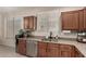 Bright kitchen with stainless steel appliances and granite countertops and wooden cabinetry at 4061 E Torrey Pines Ln, Chandler, AZ 85249