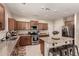 Modern kitchen featuring stainless steel appliances, granite countertops, and an island with barstool seating at 4061 E Torrey Pines Ln, Chandler, AZ 85249