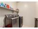 Laundry room featuring modern washer and dryer units with shelving for storage at 4061 E Torrey Pines Ln, Chandler, AZ 85249
