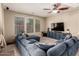 Cozy living room with a large sectional sofa, modern entertainment center, and neutral walls at 4061 E Torrey Pines Ln, Chandler, AZ 85249