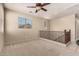 Spacious carpeted loft area featuring a ceiling fan, bright windows, and stairway access at 4061 E Torrey Pines Ln, Chandler, AZ 85249