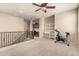 Open carpeted loft with ceiling fan, leading to office space and exercise area at 4061 E Torrey Pines Ln, Chandler, AZ 85249