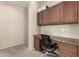 Built-in desk and cabinets in the office area featuring a stylish chair and carpeted flooring at 4061 E Torrey Pines Ln, Chandler, AZ 85249