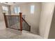 Well-lit staircase with carpeted steps and dark wood railing, connecting different levels of the home at 4061 E Torrey Pines Ln, Chandler, AZ 85249