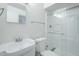 Well-lit bathroom featuring a sink, toilet, mirror, and glass door shower at 4209 N 48Th Dr, Phoenix, AZ 85031