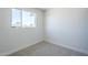 Bright bedroom has painted brick walls, carpeted floors, and a window with a view at 4209 N 48Th Dr, Phoenix, AZ 85031