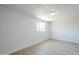 Bright bedroom featuring light wood floors, a window, painted brick walls, and a ceiling light at 4209 N 48Th Ave, Phoenix, AZ 85031