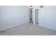 Well-lit carpeted bedroom with a closet and a door leading to another room at 4209 N 48Th Dr, Phoenix, AZ 85031