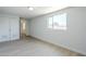 This well-lit bedroom features painted brick walls, a window, closet and light wood floors at 4209 N 48Th Ave, Phoenix, AZ 85031