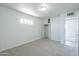 Spacious carpeted bedroom with painted brick walls, closet, and door leading to another room at 4209 N 48Th Dr, Phoenix, AZ 85031